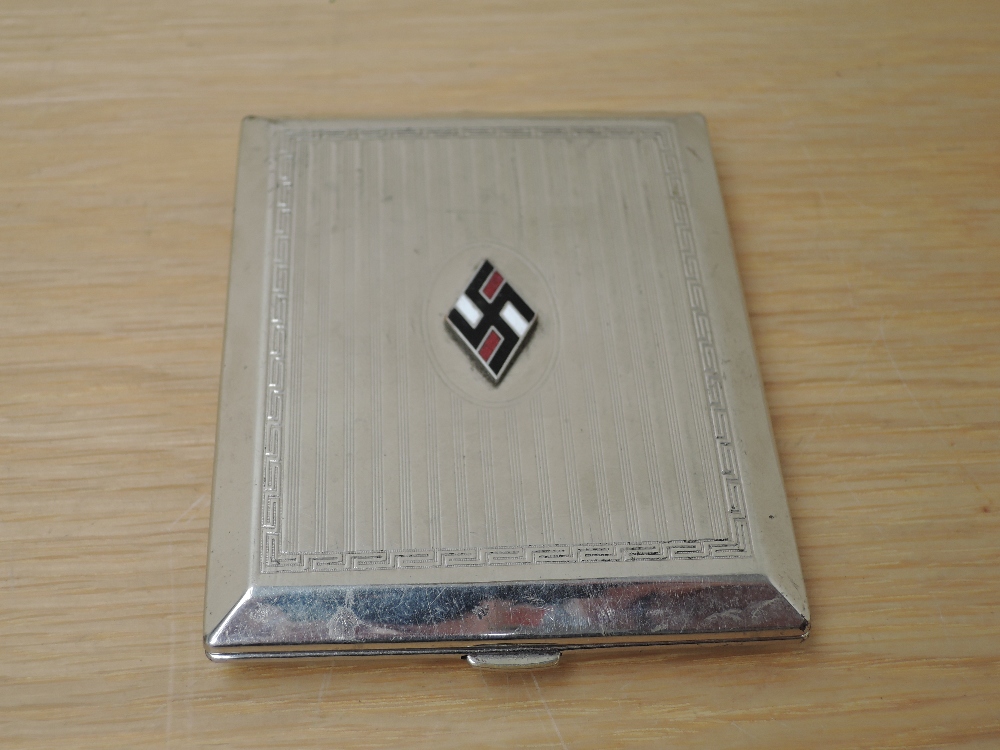 A German Third Reich silver plated Cigarette Case, bearing enamelled Swastika badge, size 10.5cm x