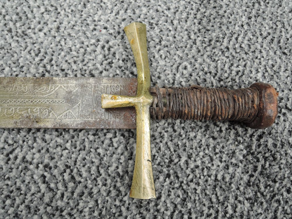 A Sudanese Kaskara Sword having highly decorated blade with Arabic script, wooden grip with - Image 2 of 11