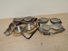 Four pairs of Googles, three leather, possible flying