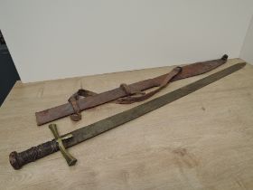 A Sudanese Kaskara Sword having highly decorated blade with Arabic script, wooden grip with