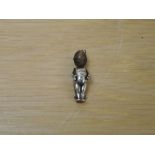 A white metal Fumsup Doll with registration number on reverse 636612, movable arms, wooden head, WWI