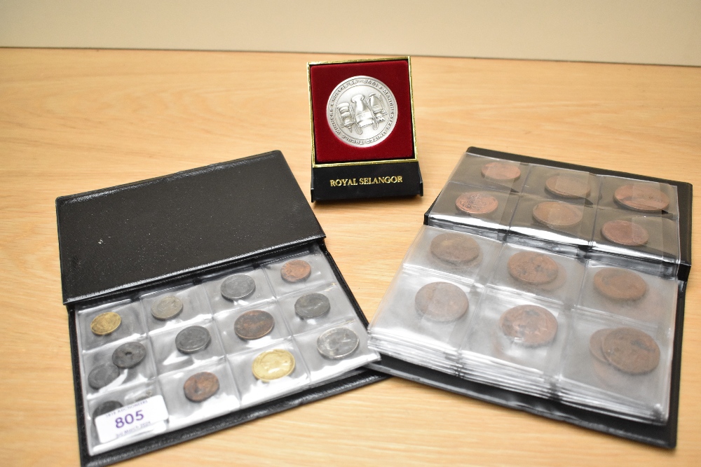 Two small folders of assorted coins, also including a Royal Selangor trophy coin celebrating