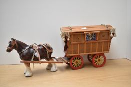 A ceramic horse and traveller's caravan.