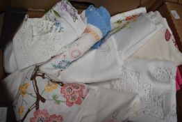 A small selection of hand embroidered and lace tablecloths.