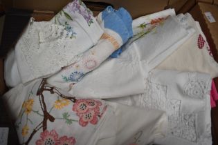 A small selection of hand embroidered and lace tablecloths.