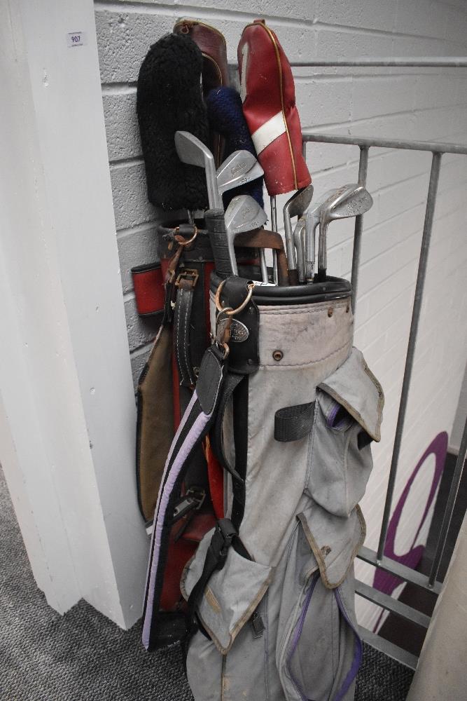 Two vintage golf bags with a small selection of north western justform clubs etc.