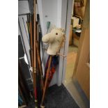 Vintage snooker cue and a selection of useful sticks, a vintage umbrella and a hobby horse toy.