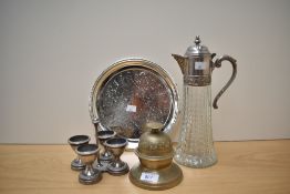A set of silver plated egg cups with stand, a vintage pressed glass and metal decanter, an Indian