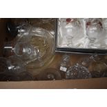 A collection of assorted glass items including cake plate, decorative bells, bonbon dishes, vases