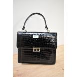 A vintage black patent handbag.