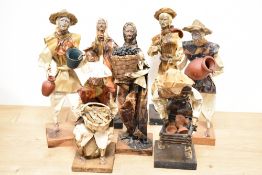 A group of seven handmade papier mache figural ornaments of Mexican village people, the largest