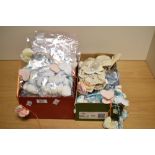 A quantity of hand-knitted babies booties, gift packed in groups of three pairs with 'it's a boy' or