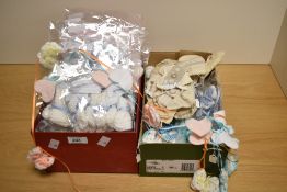 A quantity of hand-knitted babies booties, gift packed in groups of three pairs with 'it's a boy' or