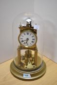 A late 19th/early 20th Century brass anniversary clock, by Gustav Becker, having an enamelled
