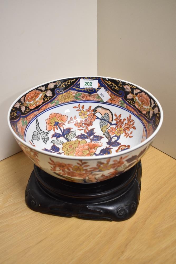 A 20th century Chinese pottery bowl, decorated with birds and blossoms with gilt highlights, printed