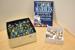 A collection of glass and stone ware marbles, various, sold together with The Outline Press Pocket