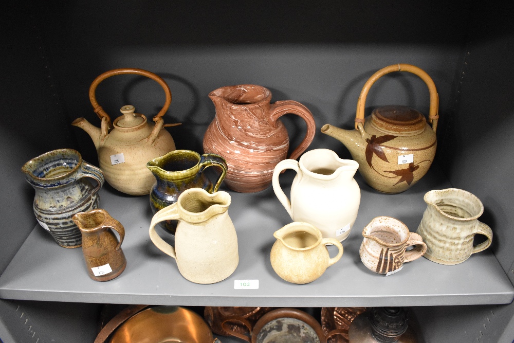 An attractive agateware pottery cider jug, of baluster form with short spout and applied loop