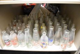 Approximately sixty vintage Dairy advertising milk bottles, various to include Stamper, Millbeck