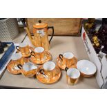 A Czechoslovakian Atlas China orange lustre porcelain coffee set, including sugar and cream, sadly