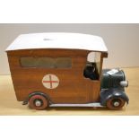 A vintage wooden ambulance ornament, measuring 29cm long