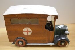 A vintage wooden ambulance ornament, measuring 29cm long