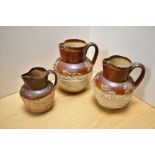 A group of three 19th century stoneware hunting jugs, half buff glazed and applied relief moulded