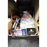 A box containing photographic equipment including Bellows, Light meters, Grips, Flash guns,