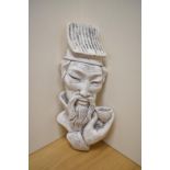 An unusual cast-plaster bust of a Chinese gentleman with tea bowl in hand, suspension loop to