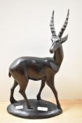 An attractive African carved-hardwood antelope study, with oval base 36cm
