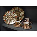 A collection of Royal Crown Derby Old Imari patterned ware, comprising two plates and two teacups