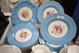 A group of nine Royal Crown Derby hand-decorated dessert plates, the gilt and mazarine blue border