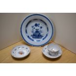 A 19th Century Delft glazed plate, possibly English, diameter 23cm, two Newhall porcelain saucers,