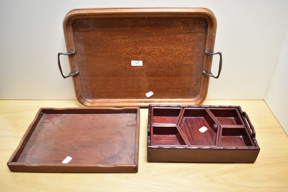 An Edwardian oak two-handled tray, of rounded rectangular form with applied coppered handles, 50cm