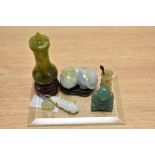 A collection of carved Chinese green stone items, to include; sleeping cat, vase, pendant, bamboo s