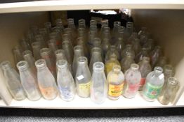 Approximately fifty vintage glass dairy advertising milk bottles, for various including J.Leigh,