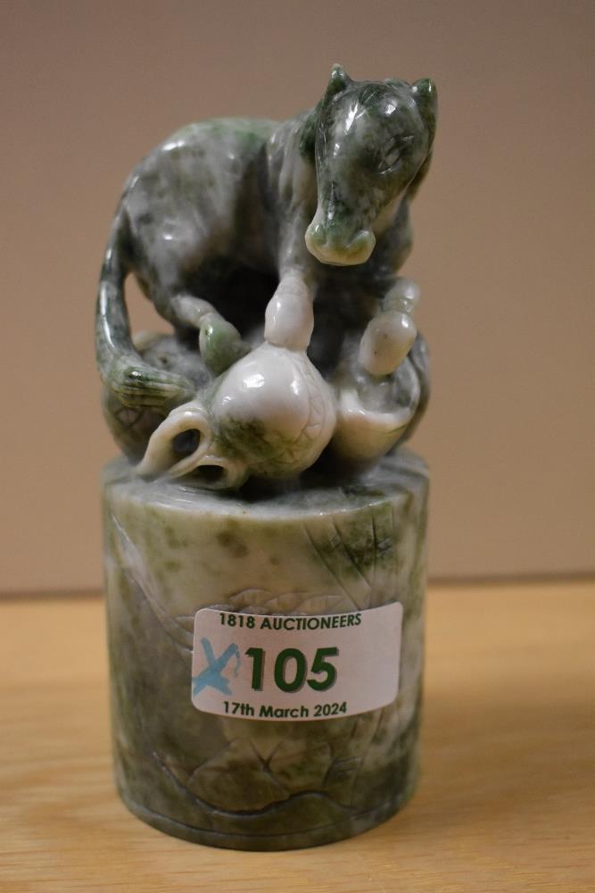 A Chinese variegated green stone seal, carved as a horse and with cylindrical base, measuring 12cm