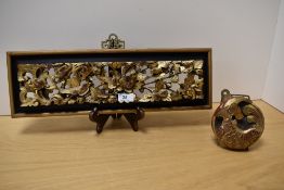 An Indian carved and pierced giltwood panel, measuring 46cm long, togther with a circular red