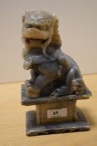 A Chinese soapstone carved Foo Dog statue, measuring 20cm tall