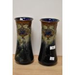 A pair of early 20th Century Royal Doulton stoneware vases, of waisted form, tube lined with a