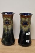 A pair of early 20th Century Royal Doulton stoneware vases, of waisted form, tube lined with a