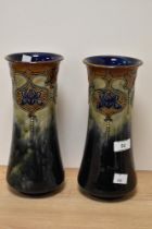 A pair of early 20th Century Royal Doulton stoneware vases, of waisted form, tube lined with a