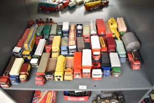 A shelf of Corgi and similar die-casts, Wagons, Tractor Units, Articulated Wagons etc