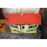 A vintage two storey Dolls House having tin plate windows, fitted and loose furniture