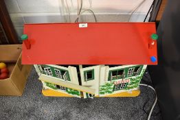 A vintage two storey Dolls House having tin plate windows, fitted and loose furniture