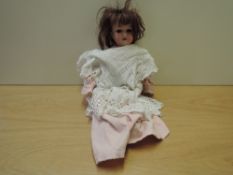 An early 20th century Armand Marseille bisque headed Doll having jointed body, marked A1M 390,
