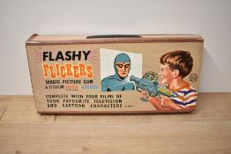 A Marx Toys Flasy Flicker Magic Picture Gun with four films present, Hi and Lois, The Phantom,