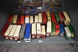 A shelf of Corgi and similar playworn die-casts, all Buses