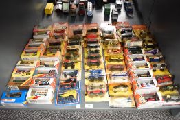A shelf of 1980's, 1990's/ 2000's Matchbox die-casts, 66 in total, all in boxes or on bubble cards