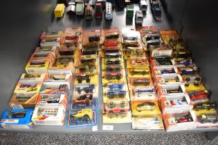 A shelf of 1980's, 1990's/ 2000's Matchbox die-casts, 66 in total, all in boxes or on bubble cards