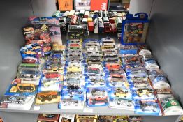 A shelf of 1990's, 2000's Mattel Hot Wheels die-casts, 65 in total all on bubble cards
